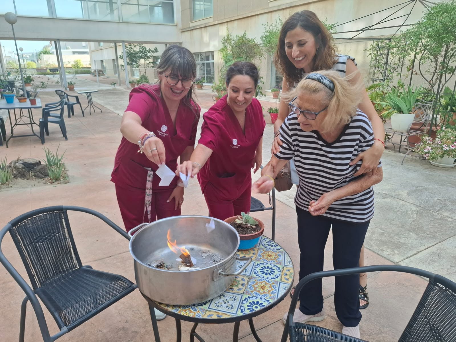 Usuaria y trabajadoras en la Hoguera de San Juan en Centro María Zayas